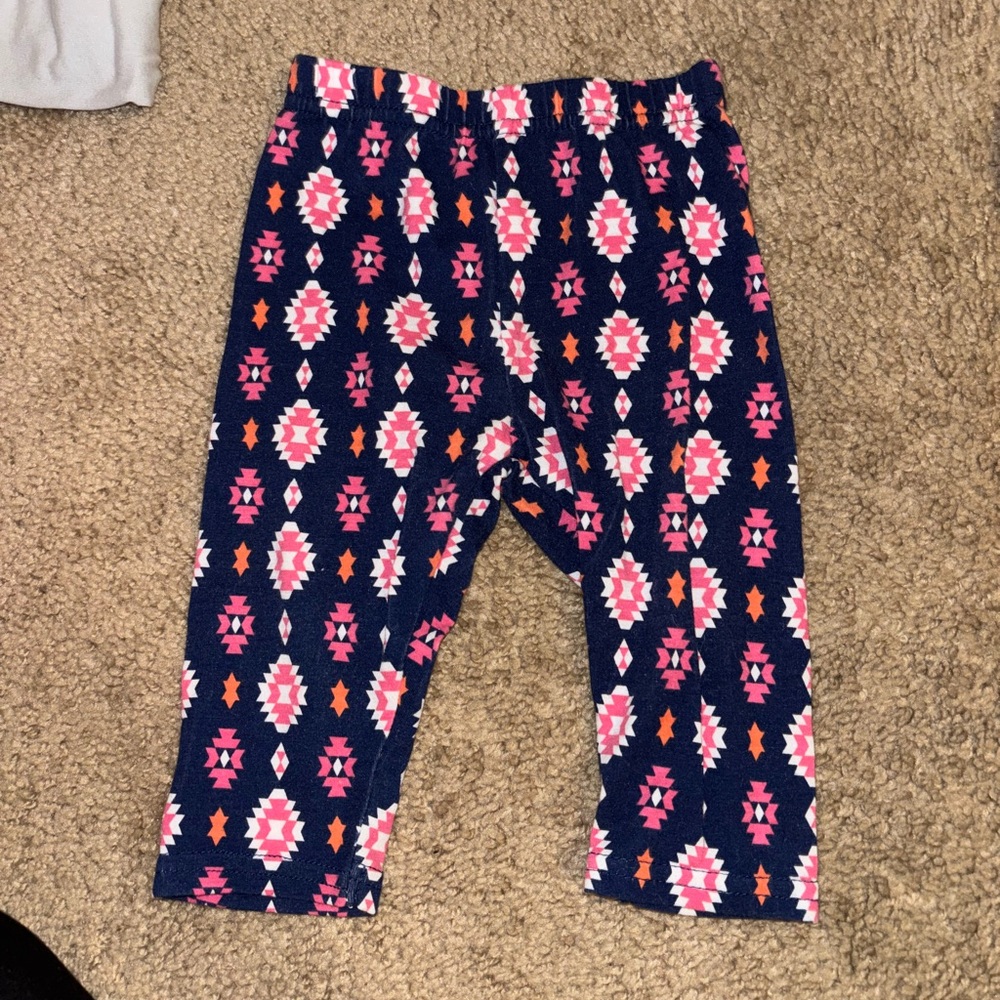 Nannette kids blue pants with pink n orange pattern all over. Size 9-12 months